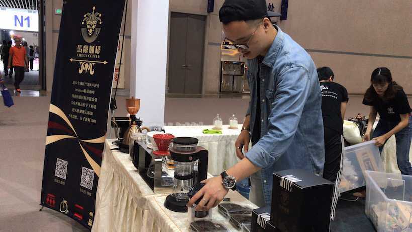 In Ethiopia Pavilion, a man is preparing the coffee for visitors