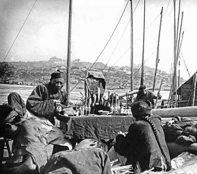Chongqing men wearing long hairs sit or lie on Chaotianmen Dock.