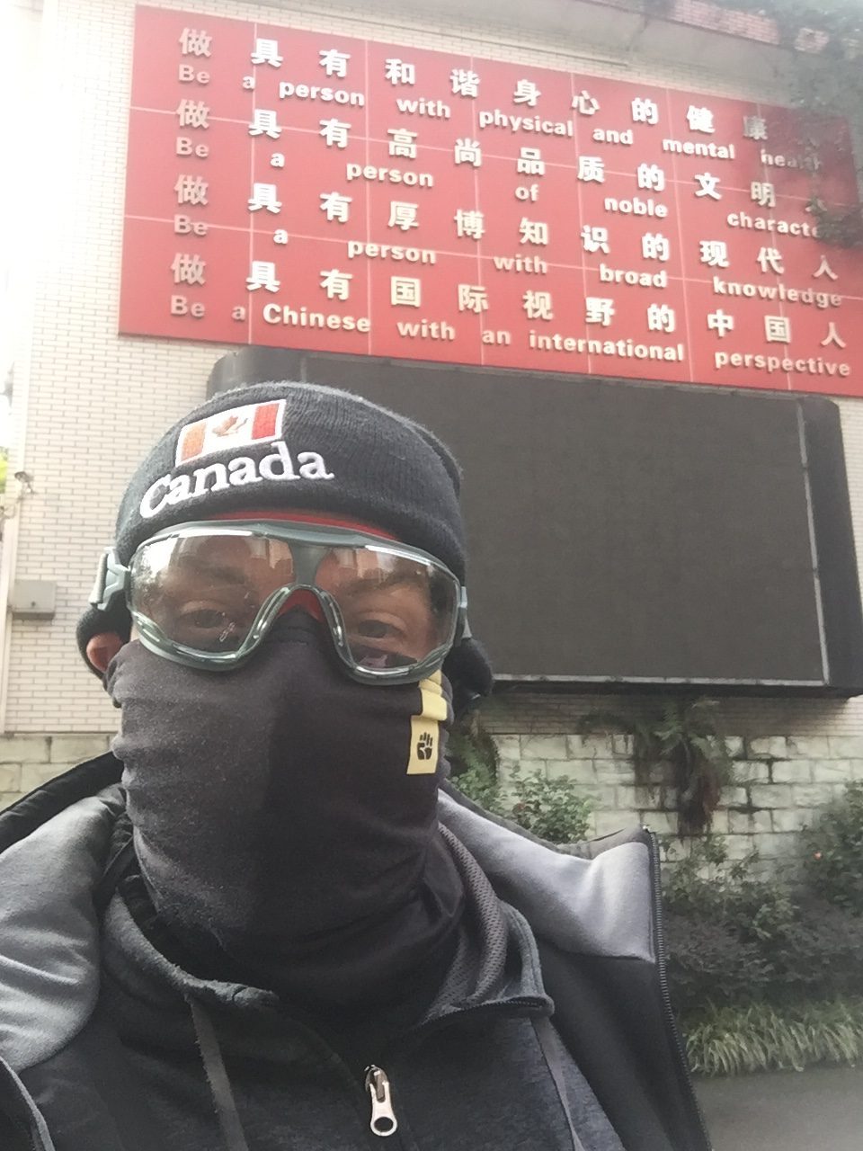 Kai in front of his school CQFLS where he is self quarantining to stay safe from 2019-nCoV