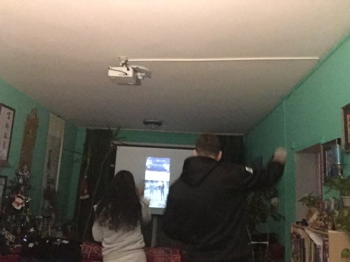 Kai tries to follow his wife as they participate in an online salsa dancing class.