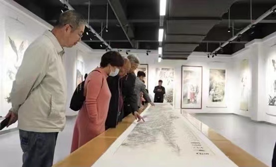 Visitors appreciating the scroll