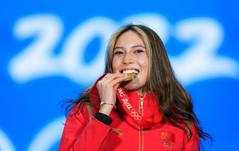 Gu Ailing celebrates on the podium after taking gold in women's free ski big air at Big Air Shougang in Beijing, capital of China, Feb 8, 2022.