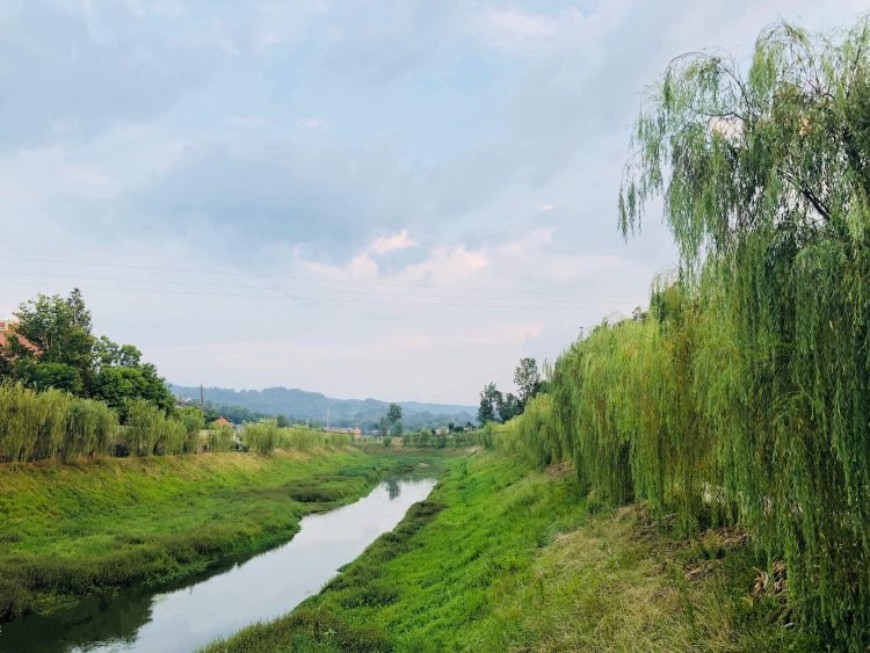 The Wenhua river with clear water and green bank.