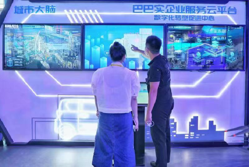 A staff member presents the function of the Babashi Enterprise Service Cloud Platform to a visitor.