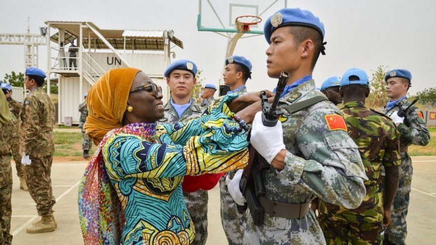 Anita Kiki Gebe, deputy joint special representative of the United Nations-African Union Mission in Darfur (UNAMID), awards UN peace medal to a soldier of the 2nd China Medium Utility Helicopter Unit (CMUHU02) in El-Fashir, Sudan, July 17, 2019. 