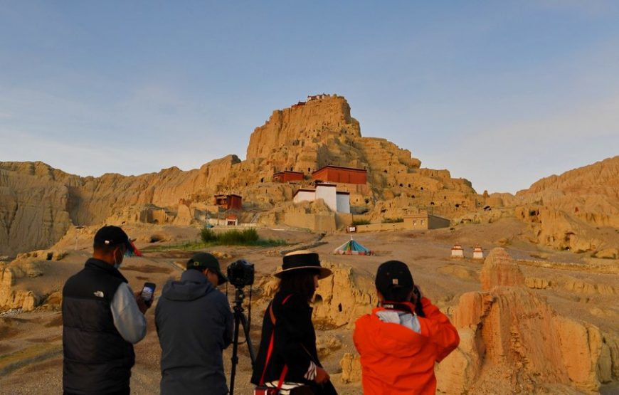 Tourists take photos of the ruins of the Guge Kingdom in Zanda County of Ngari Prefecture, southwest China's Tibet Autonomous Region, Aug. 3, 2022. (Xinhua/Zhang Rufeng)