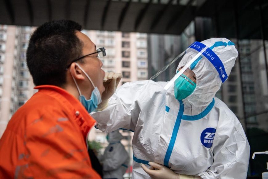 A medical worker takes a swab sample from a resident for nucleic acid testing in Chongqing.