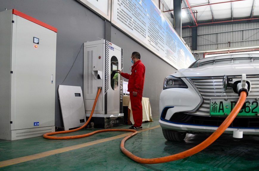 Staff inspects the charging device of a new energy vehicle in Yubei District, Chongqing, on December 8, 2022.