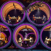 Diners enjoy the experience of eating in the “cement pipes” in a restaurant in Nanshan Mountain, Chongqing. Photo by Liu Song/Visual Chongqing.