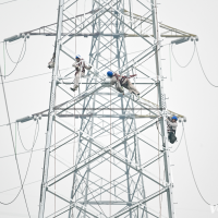 In Changshou District, diligent power crews work on the tower to ensure a steady electricity supply in summer. Photo by Zhang Songdong/Visual Chongqing