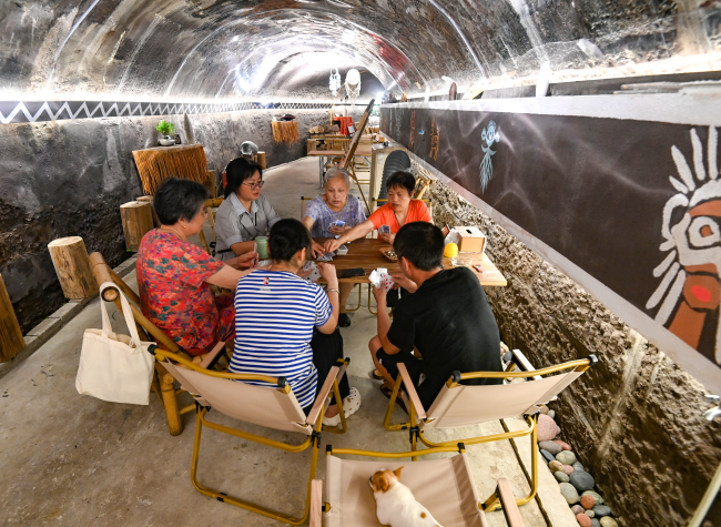 Chongqing Air Raid Shelter Offers Relief From Heat With Live Music
